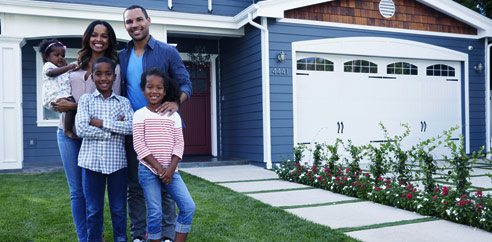 family standing in front of home